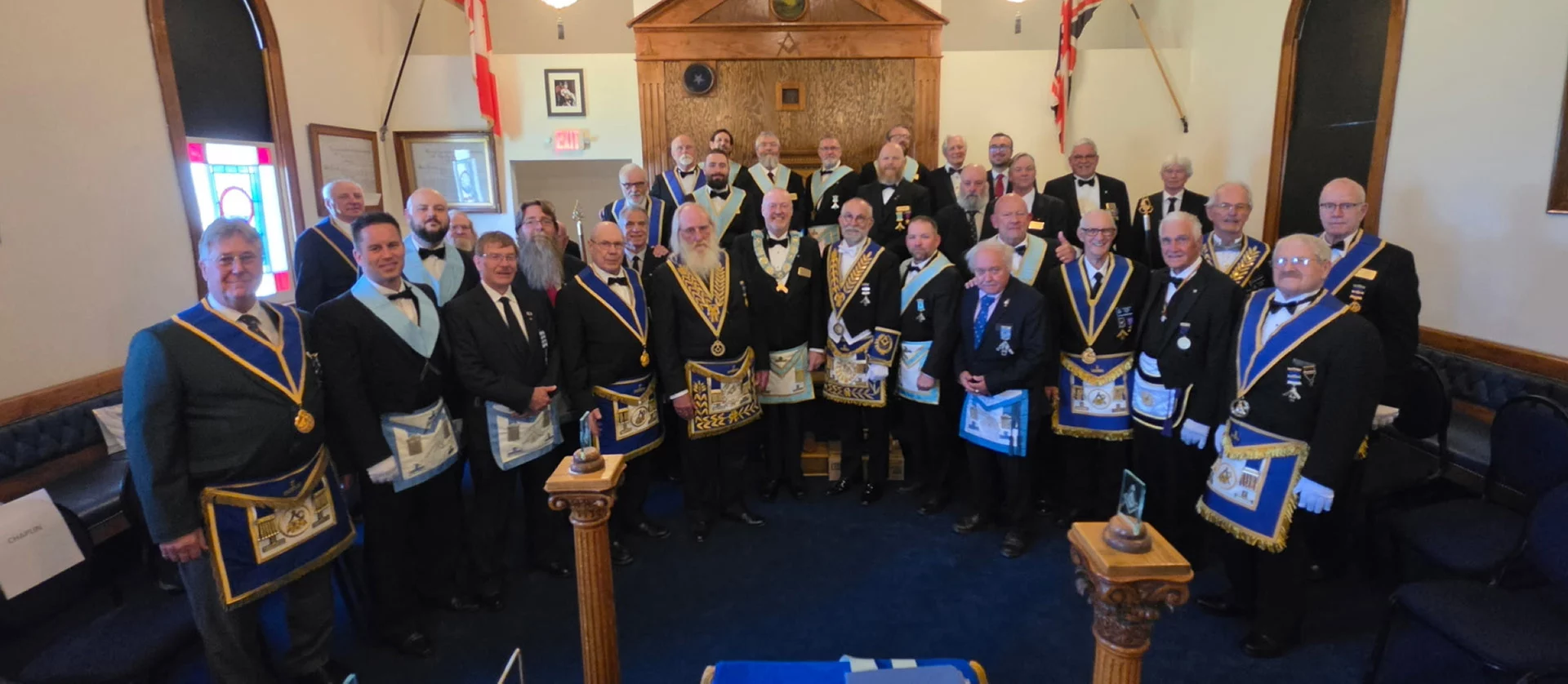 pic one Smiling group of men standing in lodge together.