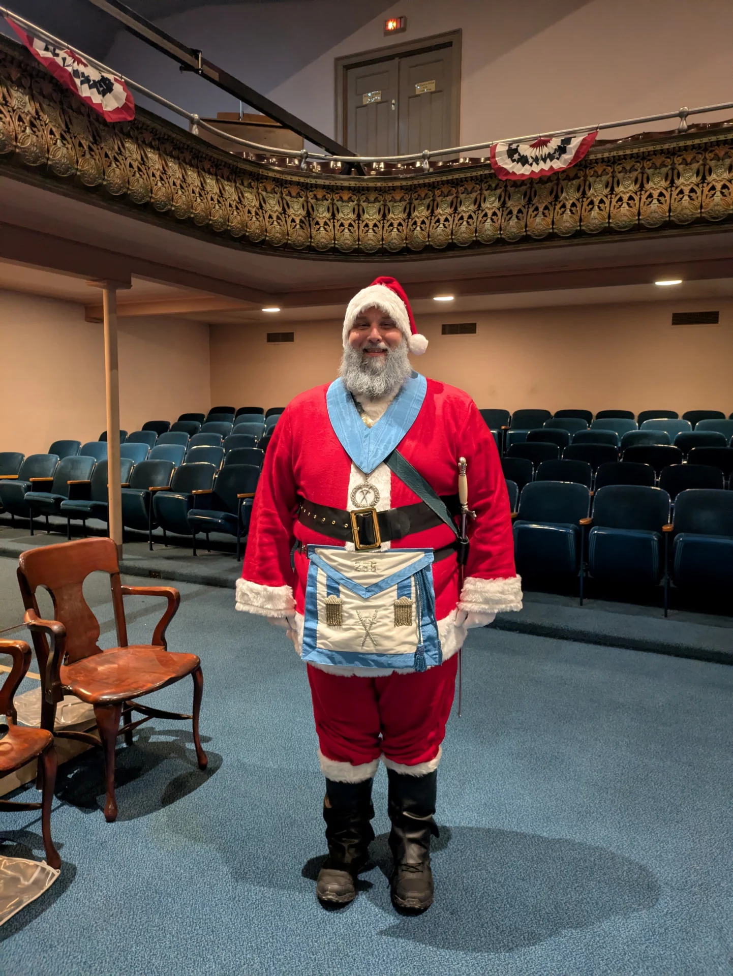 Mason dressed as Santa standing in a lodge room.