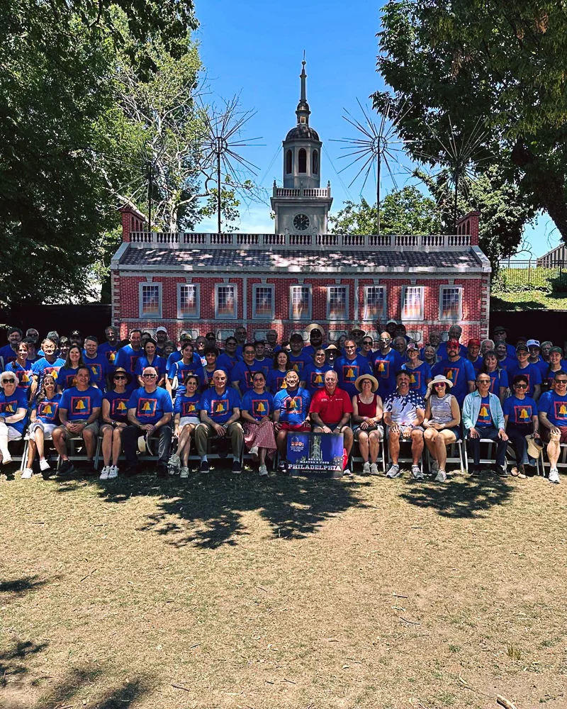 742531034_869089755854662_2299035233885041245_n Large group posed in front of a brick building outdoors/