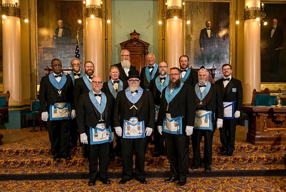 GLPANJ08.22-0095 Smiling group of Masons standing together in a lodge room.