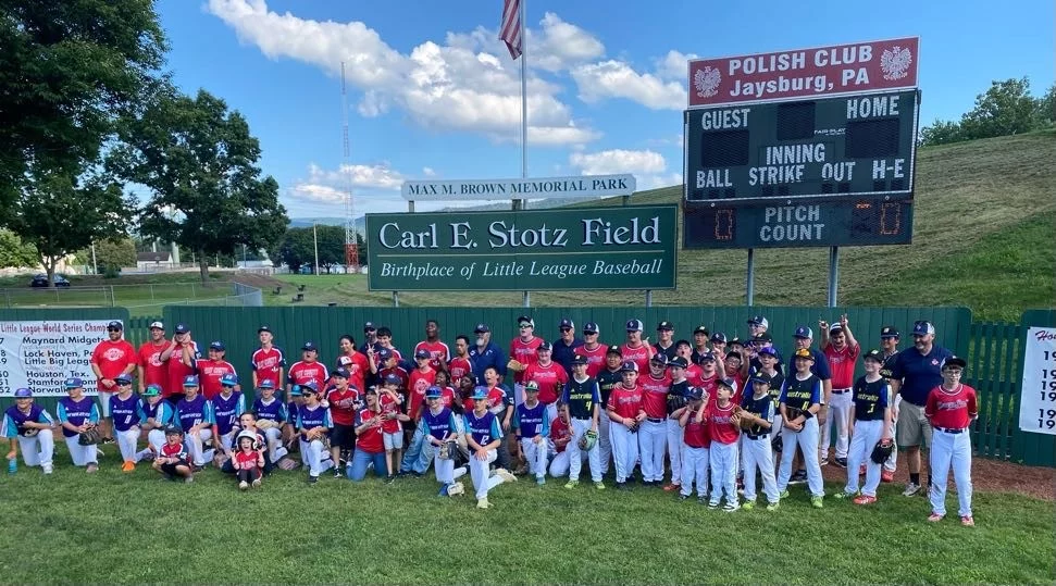 GroupPhoto Group of children and coaches together on the Carl E. Stotz Field.